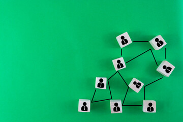 Building a strong team, Wooden blocks with people icon on blue background, Human resources and management concept.