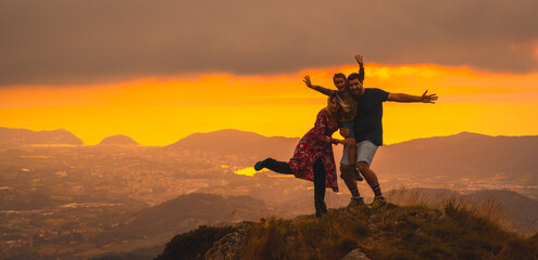 Mother and father next to his son having fun in a beautiful sunset in the mountain. Adventure...