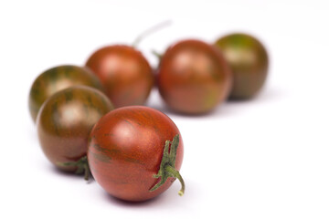 a row of tomatoes zebra ripe and not ripe isolated on a white background. selective focus