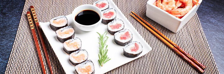 Presentation of a plate with sushi and a bowl of soy sauce. Asian food. Healthy food concept