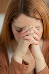 closeup portrait of a young woman praying