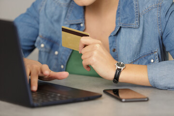 woman holding credit card shopping online