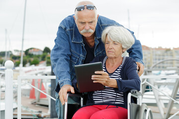 lovely senior couple using tablet