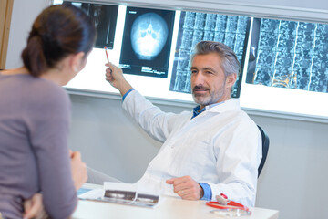 doctor showing mri scan results to female patient