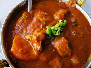 Indian lamb curry in a copper bowl. 