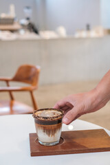 Dirty Coffee - A glass of espresso shot mixed with cold fresh milk in coffee shop cafe and restaurant