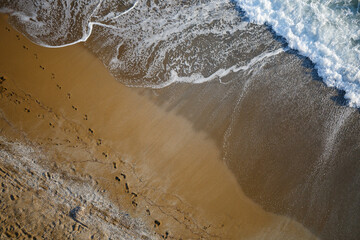 Beautiful view from above on the sandy beach that washes the sea water
