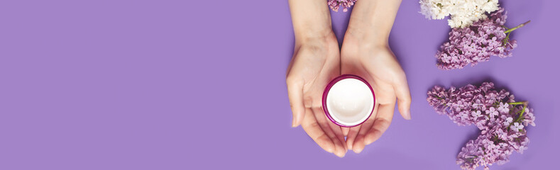 facial body cosmetic products, lilac flowers blossom on white desktop background whith copy space. spring skin care layout. Natural beauty product concept. top view, flat lay.