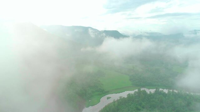 Aerial video of clouds, mountains, forest and mountain river