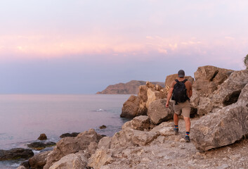 Fototapeta premium one hiker men walking on the shore of Black sea in the Crimea