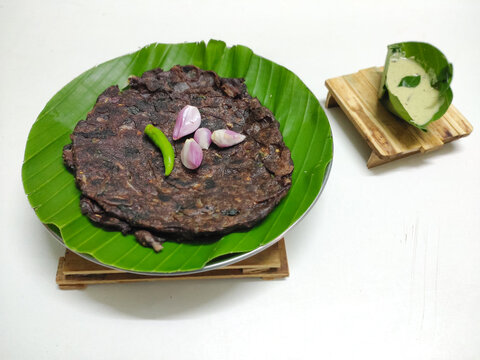 Protein rich Ragi roti made from Finger millet placed in a banana leaf plate and served with chutney . South indian dish. Breakfast. Traditional.