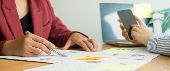 Two business leaders talk about charts, financial graphs showing results are analyzing and calculating planning strategies, business success building processes