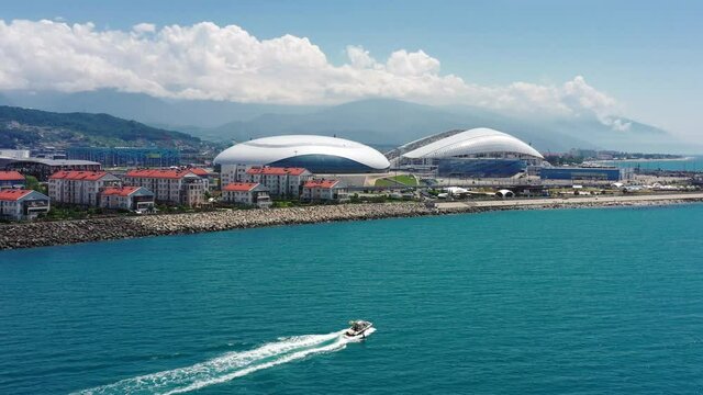 Aerial view Football stadium Fischt. Sochi, Adler, Russia. Cityscape modern olympic park new sports buildings epic dome. Futuristic architecture. Cinematic Russia landmark. Blue sea coastal area. 