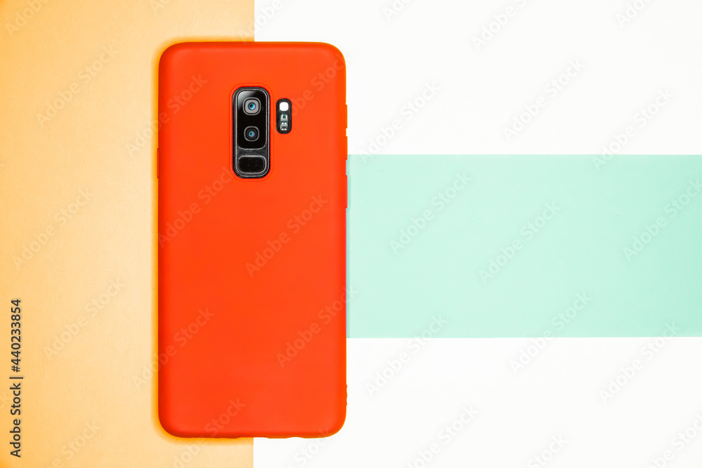 Poster top view of a phone with a red case on a colorful background