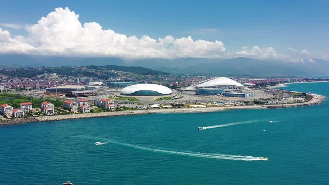 Aerial view Football stadium Fischt. Sochi, Adler, Russia. Cityscape modern olympic park new sports buildings epic dome. Futuristic architecture. Cinematic Russia landmark. Blue sea coastal area. 