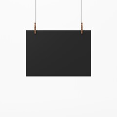 Fototapeta premium Black horizontal Poster Mockup on wooden clothespins on white background, 3d rendering