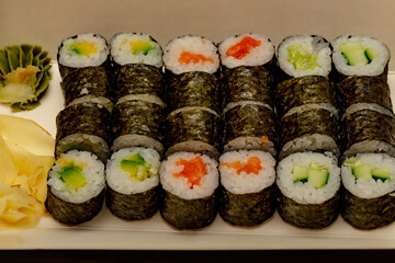 Rolls with salmon, cucumber and avocado.