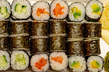Rolls with salmon, cucumber and avocado.