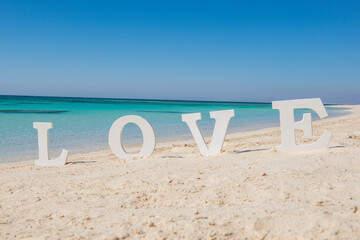 Romantic love sign on a tropical beach paradise