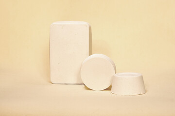 Empty white  podium on pastel beige color background. Minimal boxes and geometric podium. Scene with geometrical forms. Empty showcase for cosmetic product presentation. Fashion magazine.