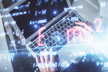 Double exposure of woman hands working on computer and formula hologram drawing. Top View. Science concept.