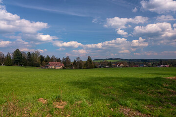 Obraz premium View of the picturesque Czech village with beautiful landscapes, meadows and views of the surroundings.