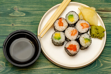 Rolls with salmon, cucumber and avocado.