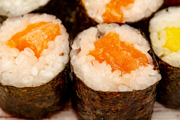 Rolls with salmon, cucumber and avocado.