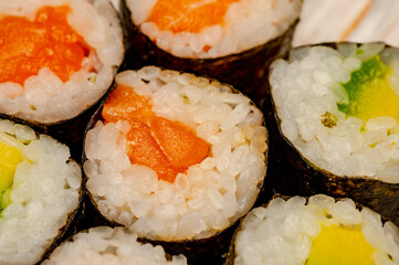 Rolls with salmon, cucumber and avocado.