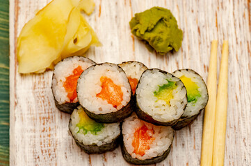 Rolls with salmon, cucumber and avocado.