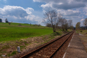 Railway tracks leading to the unknown hidden in meadows in the Czech Republic.