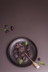 Blackberries on a ceramic plate, frozen fruits for a healthy food diet