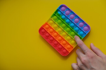  New sensory antistress toy for children and adult.Pop it on the colorful background