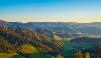 Naklejka premium Germany, Schwarzwald aerial panorama nature landscape view above colorful valley and village houses from above at sunset in spring