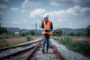 Engineer under inspection and checking construction process railway switch and checking work on...