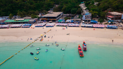 Fototapeta na wymiar Aerial top view of beautiful tropical beach with white sand and turquoise clear water, many boats on Tawaen beach Ko Larn island, Chon Buri Thailand 