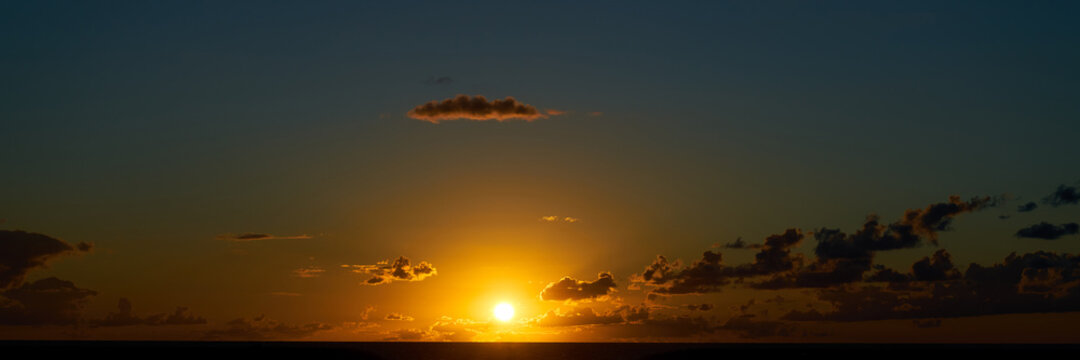 Sunset as a panorama background with clouds © Robert Kneschke