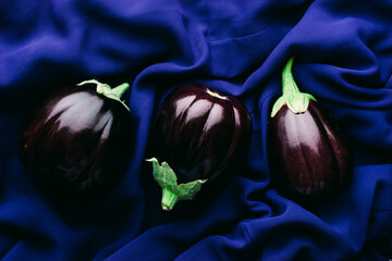 three fresh organic eggplants