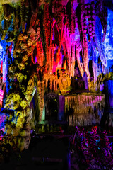 Nice cave formed by nature with stalactites, stalagmites, karst limestone