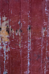 old scratched red painted wooden door texture background 