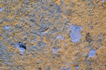 yellow gray texture of the old scratched stone house wall