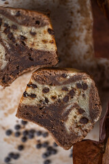 Soft and moist chocolate banana muffins with dark chocolate drops on grey rustic table. Homemade baked twisted cupcakes. Natural light, selective focus, copy space