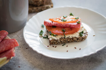 Cooked breakfast with coffee and sandwich. All this on a gray background