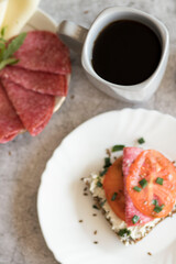 Cooked breakfast with coffee and sandwich. All this on a gray background