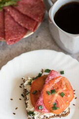 Cooked breakfast with coffee and sandwich. All this on a gray background
