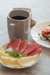 Cooked breakfast with coffee and sandwich. All this on a gray background