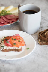 Cooked breakfast with coffee and sandwich. All this on a gray background