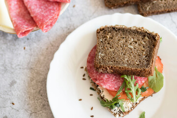 Cooked breakfast with coffee and sandwich. All this on a gray background