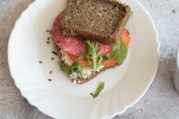 Cooked breakfast with coffee and sandwich. All this on a gray background