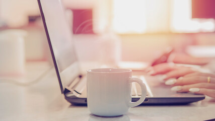 Coffee cup and laptop computer